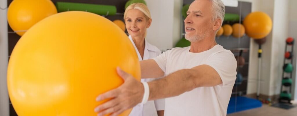 Old man doing physical therapy exercise to live pain free